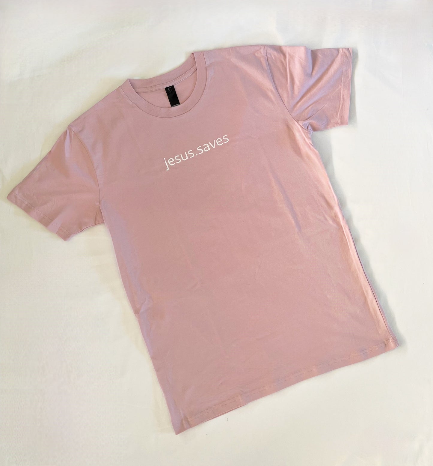 Wear your faith with the newest addition to our jesus.saves line. Our minimalistic jesus.saves design on Blush Pink Classic T-shirts Helping you to wear your faith in a stylish and powerful way Pair with a Blush jesus.saves Lightweight Sweatshirt to create a matching fit! Material: 100% Australian Cotton Screenprinted with plastisol ink Details: Straight Hem High chest print Bottom right back SSD print
