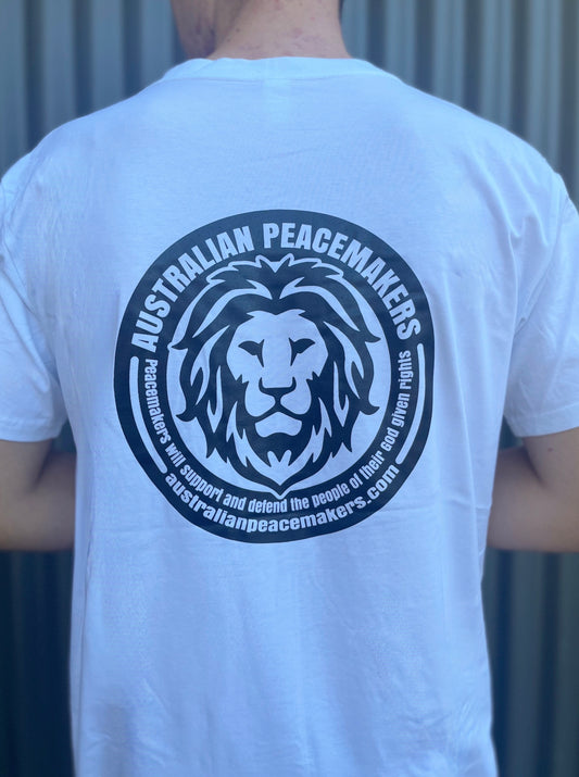 White tee with blank front. Back Black ink print with Australian Peace Maker lion face image and statement of peacemakers. TEXT - Peacemakers will support and defend the people of their God given rights.